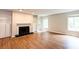 Cozy living room with a fireplace and natural light, complemented by wood floors throughout at 591 Emory Oaks Way # 591, Decatur, GA 30033