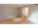Spacious living room with neutral walls and carpet, and entrance to bathroom at 591 Emory Oaks Way # 591, Decatur, GA 30033