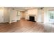 Bright living room featuring a fireplace, built-in shelves, and access to the outdoors with wood floors at 591 Emory Oaks Way # 591, Decatur, GA 30033