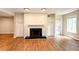 Spacious living room with fireplace and built-in features, enhanced by stylish wood flooring at 591 Emory Oaks Way # 591, Decatur, GA 30033