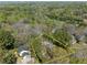 Aerial view of property surrounded by lush trees in a neighborhood with distant skyline at 2386 Bohler Nw Rd, Atlanta, GA 30327