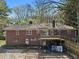 Back exterior view showing the brick facade, deck, patio, and windows of the home at 2386 Bohler Nw Rd, Atlanta, GA 30327