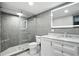 Modern bathroom featuring glass shower, gray tile, and vanity with marble countertop at 2676 Cottonwood Dr, Marietta, GA 30066
