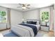 Well-lit bedroom featuring a plush bed with blue accents and matching bedside tables at 2676 Cottonwood Dr, Marietta, GA 30066