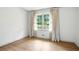 A charming bedroom with a large window and light hardwood floors at 2676 Cottonwood Dr, Marietta, GA 30066