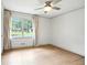 Bright, empty bedroom showcasing hardwood floors, large windows and neutral decor at 2676 Cottonwood Dr, Marietta, GA 30066