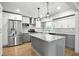 Bright kitchen with white cabinets, stainless appliances, granite counters, and a central island at 2676 Cottonwood Dr, Marietta, GA 30066