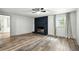 Spacious living room with dark brick fireplace, new flooring, and natural light at 2676 Cottonwood Dr, Marietta, GA 30066