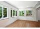 Brightly lit room with hardwood floors and multiple windows framing a natural view at 2676 Cottonwood Dr, Marietta, GA 30066