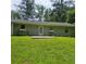 A well-manicured backyard featuring a stone foundation, white trim and lush greenery at 3645 Shrewsbury Ct, Snellville, GA 30039