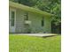 A backyard featuring a stone foundation and concrete patio surrounded by lush greenery at 3645 Shrewsbury Ct, Snellville, GA 30039