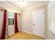 Bedroom with tile flooring, window with red drapes, and a door at 3645 Shrewsbury Ct, Snellville, GA 30039
