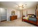 Bedroom featuring a four-poster bed, dresser with mirror, and access to a side room at 3645 Shrewsbury Ct, Snellville, GA 30039