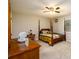 Cozy bedroom with four-poster bed and natural light from the window at 3645 Shrewsbury Ct, Snellville, GA 30039