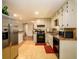 Spacious kitchen with stainless steel refrigerator, black appliances, and tile flooring at 3645 Shrewsbury Ct, Snellville, GA 30039