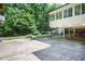 Spacious backyard featuring mature trees, a basketball court, and large deck area for outdoor entertaining and activities at 377 Camden Ne Rd, Atlanta, GA 30309