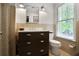 Vintage bathroom with dark vanity, neutral colored tile, and natural light at 377 Camden Ne Rd, Atlanta, GA 30309