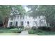 Charming two-story white brick home with mature trees and landscaping, offering great curb appeal at 377 Camden Ne Rd, Atlanta, GA 30309