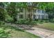 A lovely two-story home with great curb appeal, featuring a manicured lawn and a driveway gate at 377 Camden Ne Rd, Atlanta, GA 30309