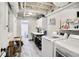 Functional laundry room with white appliances, folding area, and tile flooring at 377 Camden Ne Rd, Atlanta, GA 30309