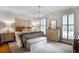Serene main bedroom featuring neutral tones, ample natural light, and stylish furnishings at 377 Camden Ne Rd, Atlanta, GA 30309