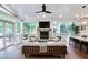Relaxing outdoor space with fireplace, comfortable seating, and ceiling fan at 377 Camden Ne Rd, Atlanta, GA 30309