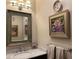 Elegant powder room featuring a marble countertop, decorative artwork, and stylish fixtures at 377 Camden Ne Rd, Atlanta, GA 30309