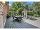 Spacious outdoor deck features a dining area, outdoor furniture, and a wooded view at 1155 Admiral Xing, Alpharetta, GA 30005