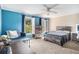 This secondary bedroom features abundant natural light, a ceiling fan, and blue accent wall at 1155 Admiral Xing, Alpharetta, GA 30005