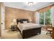 Cozy bedroom with neutral tones, plantation shutters and wood trim at 1155 Admiral Xing, Alpharetta, GA 30005