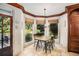 Bright breakfast nook featuring travertine floors, wood trim, and backyard views at 1155 Admiral Xing, Alpharetta, GA 30005