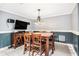 Dining room with modern chandelier and wainscoting, a great space to entertain at 1155 Admiral Xing, Alpharetta, GA 30005