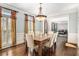 Bright dining room with hardwood floors, large windows and modern lighting at 1155 Admiral Xing, Alpharetta, GA 30005