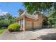 Brick home featuring a three-car garage and mature landscaping, with a beautiful yard at 1155 Admiral Xing, Alpharetta, GA 30005