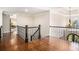 Upstairs hallway featuring hardwood floors, wrought iron railings and backyard views at 1155 Admiral Xing, Alpharetta, GA 30005