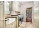 Well-equipped laundry room with sink, stainless steel appliances and stone tile flooring at 1155 Admiral Xing, Alpharetta, GA 30005