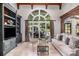 Comfortable living room featuring built-in shelves and large windows with backyard views at 1155 Admiral Xing, Alpharetta, GA 30005