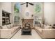 Bright living room featuring a stone fireplace, ceiling fan and built-in bookcase at 1155 Admiral Xing, Alpharetta, GA 30005