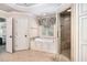 This light-filled bathroom offers a separate shower, tub, and easy access to the main bedroom and walk-in closet at 1155 Admiral Xing, Alpharetta, GA 30005