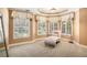 This bright sitting room offers comfortable furnishings, plantation shutters, and lush backyard views at 1155 Admiral Xing, Alpharetta, GA 30005