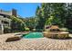 Beautiful backyard with a stone-lined swimming pool and hot tub, surrounded by lush landscaping at 1155 Admiral Xing, Alpharetta, GA 30005