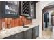 Wet bar featuring dark cabinetry, wine rack and granite countertop at 1155 Admiral Xing, Alpharetta, GA 30005