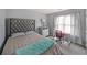 Comfortable bedroom featuring a tufted headboard, large window, and a desk area at 4321 Clairesbrook Ln, Acworth, GA 30101