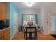 Cozy dining area with a large window, hardwood floors, and access to the outside at 4321 Clairesbrook Ln, Acworth, GA 30101