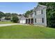 Stylish two-story home with lush green lawn, attached two-car garage and covered porch with seating at 4321 Clairesbrook Ln, Acworth, GA 30101