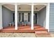 Inviting front porch with seating, decorative columns, and a welcoming entrance at 4321 Clairesbrook Ln, Acworth, GA 30101