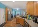 Spacious eat-in kitchen with stainless appliances, wood cabinets, and dining area access at 4321 Clairesbrook Ln, Acworth, GA 30101