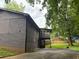 View of the back of the brick home with a covered porch and ample backyard space at 4325 Dawning Ln, Douglasville, GA 30135