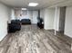 This finished basement has a gray wood floor, overhead lighting, and plenty of space to entertain friends and Gathering at 4325 Dawning Ln, Douglasville, GA 30135