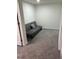 This basement room has carpeted floors, and a futon for extra sleeping area, creating a relaxing space at 4325 Dawning Ln, Douglasville, GA 30135